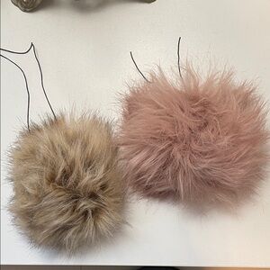 A pair of handmade faux fur pom-poms in EUC